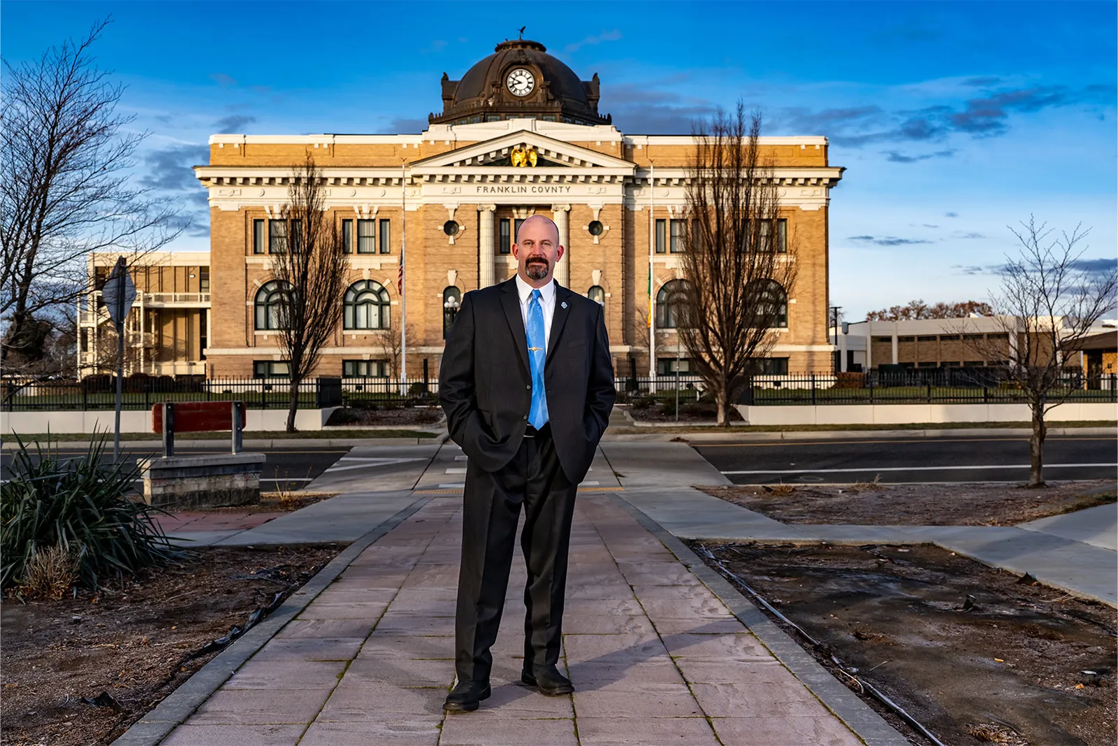 Chris Lee standing on the walkway in front of the Franklin County Courthouse in Pasco
